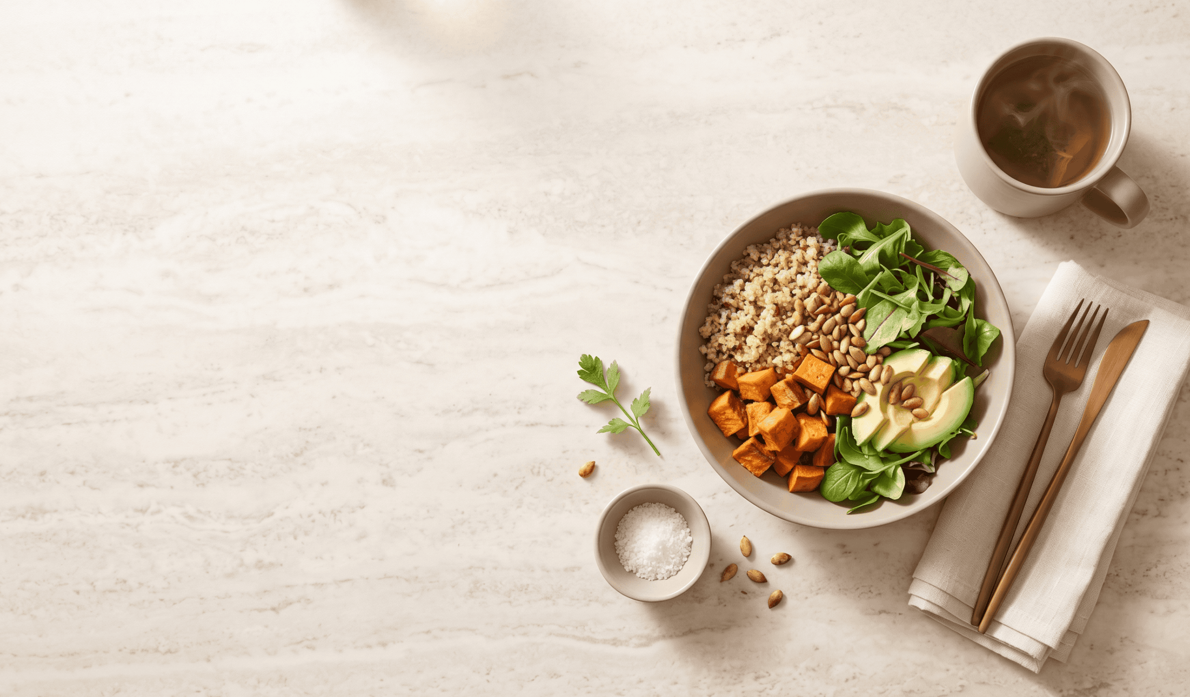 http://Bowl%20saludable%20con%20quinoa,%20camote,%20palta,%20hojas%20verdes%20y%20semillas%20junto%20a%20una%20taza%20de%20té%20de%20hierbas%20sobre%20mesa%20de%20mármol.